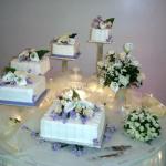Square cakes using buttercream icing with fondant accents and silk flowers served 250